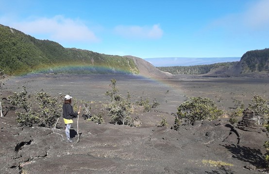 Person with Walking Stick by Rainbow